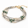 Women's multi-strand layered bracelet featuring lustrous cream white pearls, deep green accent beads, gunmetal seed chains, and a gold-tone ring clasp.
