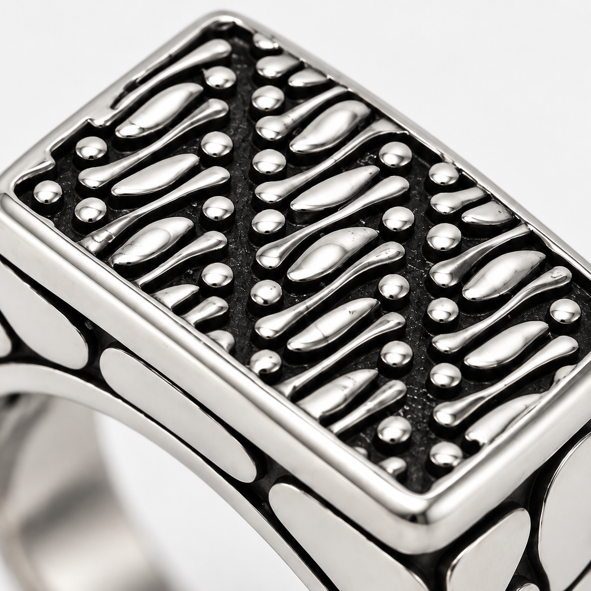 Macro close-up of textured diagonal mosaic pattern on rectangular signet face
