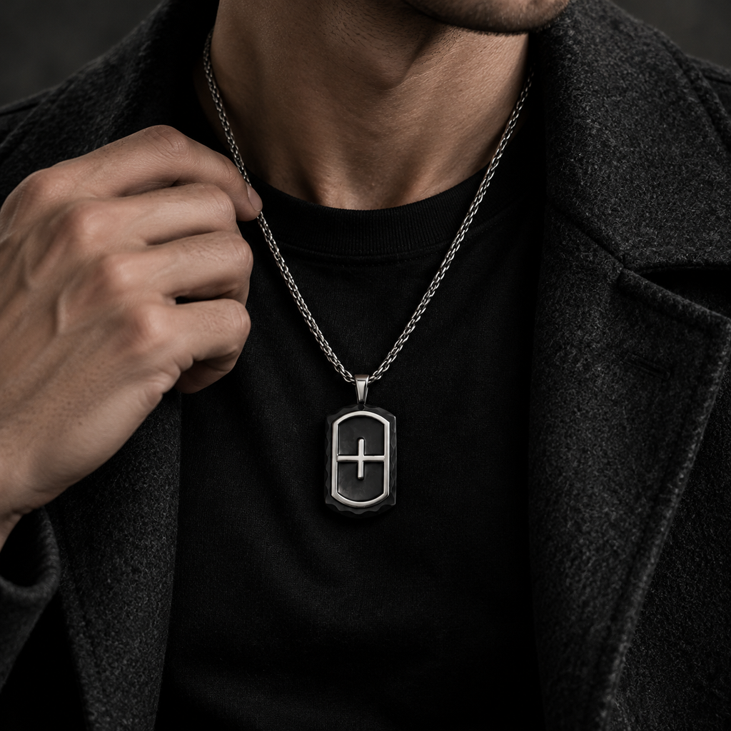 Model wearing men's heraldic cross shield tag pendant necklace with charcoal wool coat
