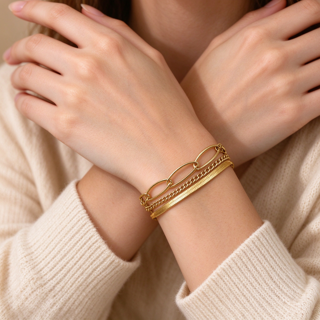 Close-up of model wearing 18K gold plated multi-layer chain bracelet on wrist
