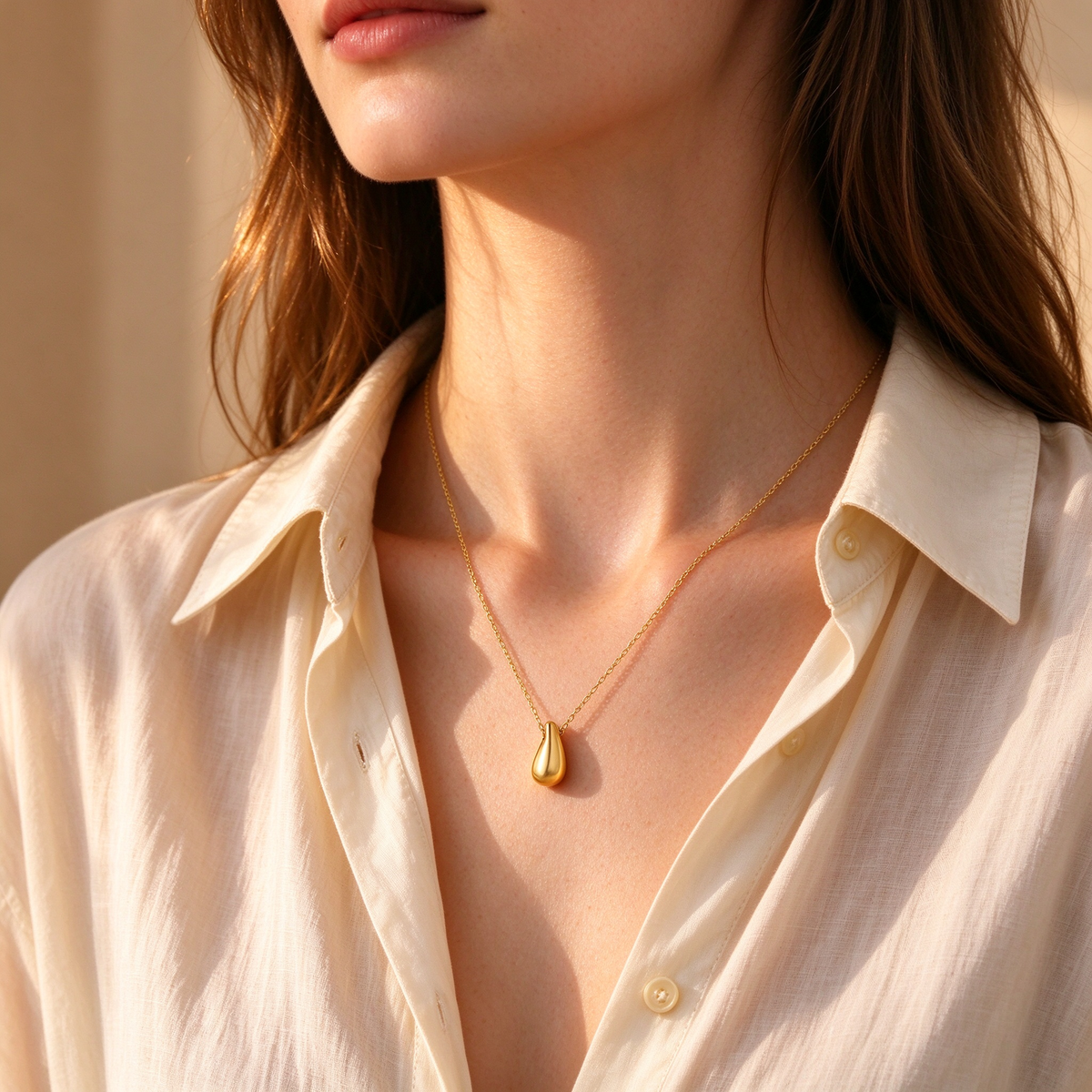 Side view of women's dainty gold teardrop pendant necklace everyday jewelry
