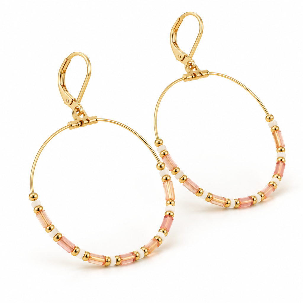 Outdoor lifestyle shot of model wearing elegant bohemian pink and gold beaded large hoop earrings paired with white textured blouse
