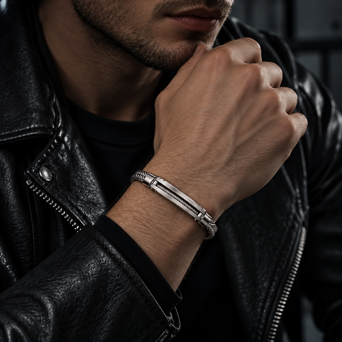 Model wearing men's steel cable inset ID bracelet with black leather jacket
