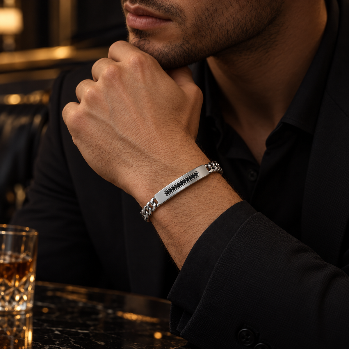 Model wearing men's channel-set black stone ID bracelet with formal black suit
