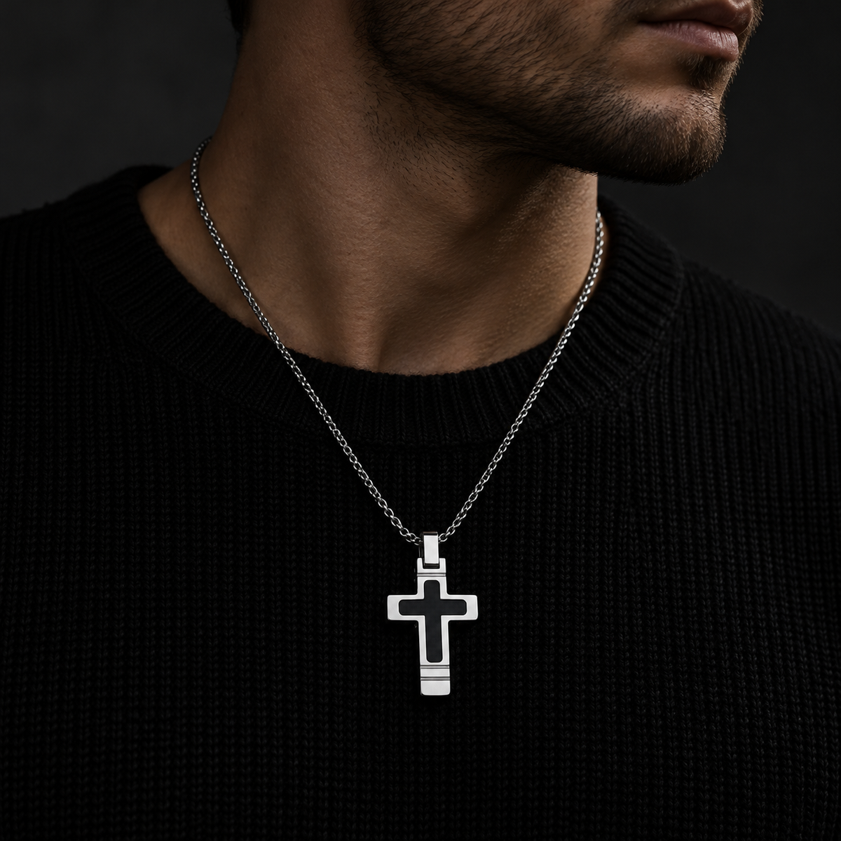 Model wearing men's chamfered cross pendant necklace on dark crewneck sweater
