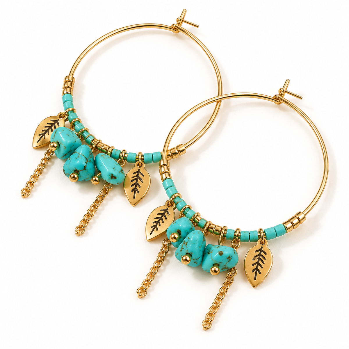 Angled studio shot of two women's turquoise stone beaded gold hoop earrings with delicate chain tassels and leaf charms
