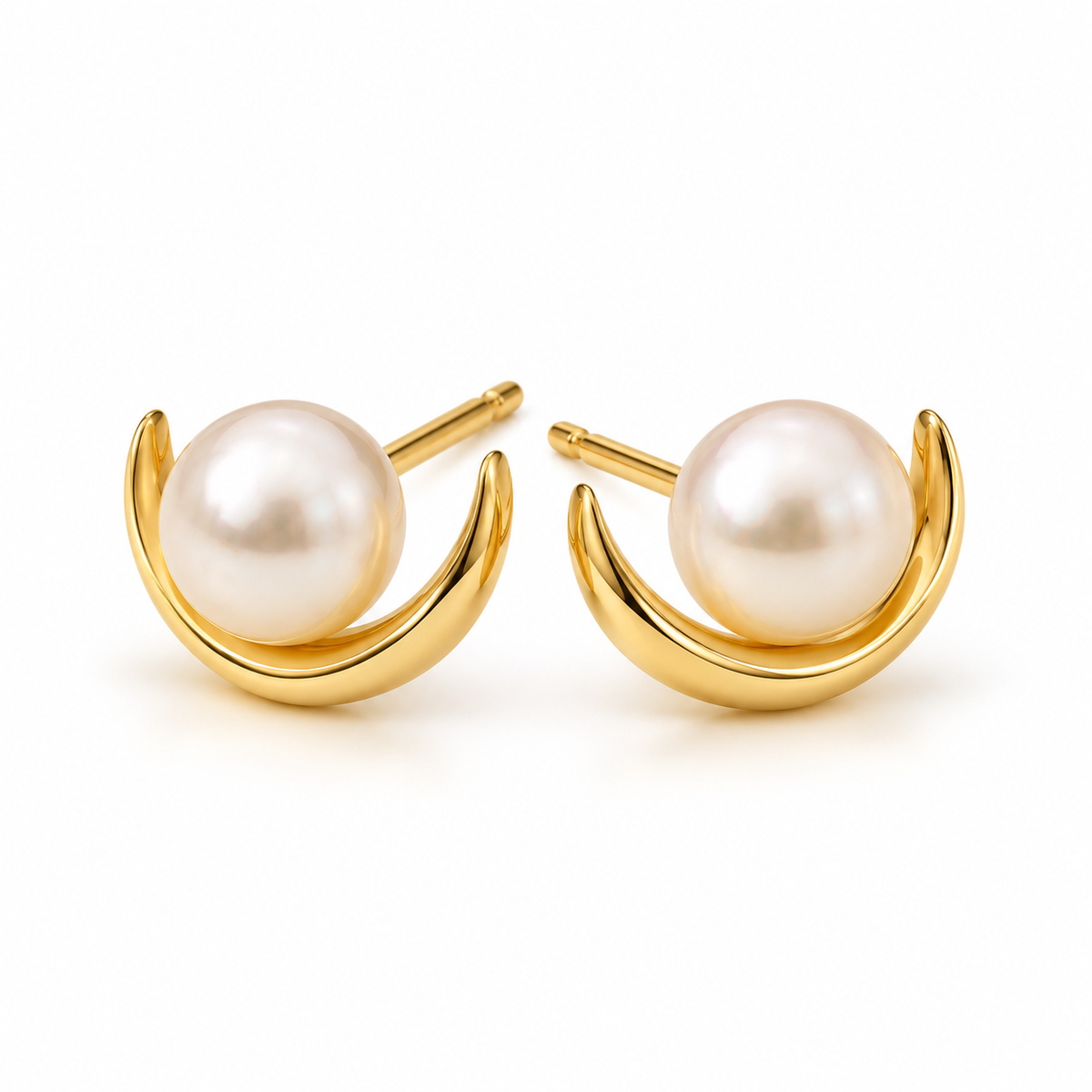 Studio front view of symmetrical gold crescent arc pearl stud earrings
