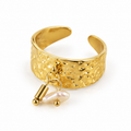 Hammered 18K gold plated wide band open ring with dangling freshwater pearl and gold bar charms on white background
