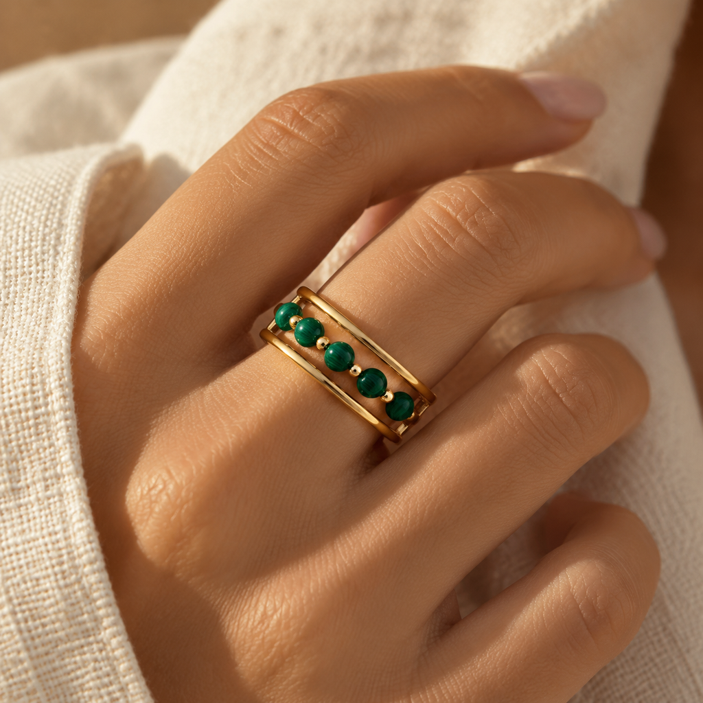 Lifestyle shot of woman wearing elegant green malachite bead triple row adjustable ring in sunlight
