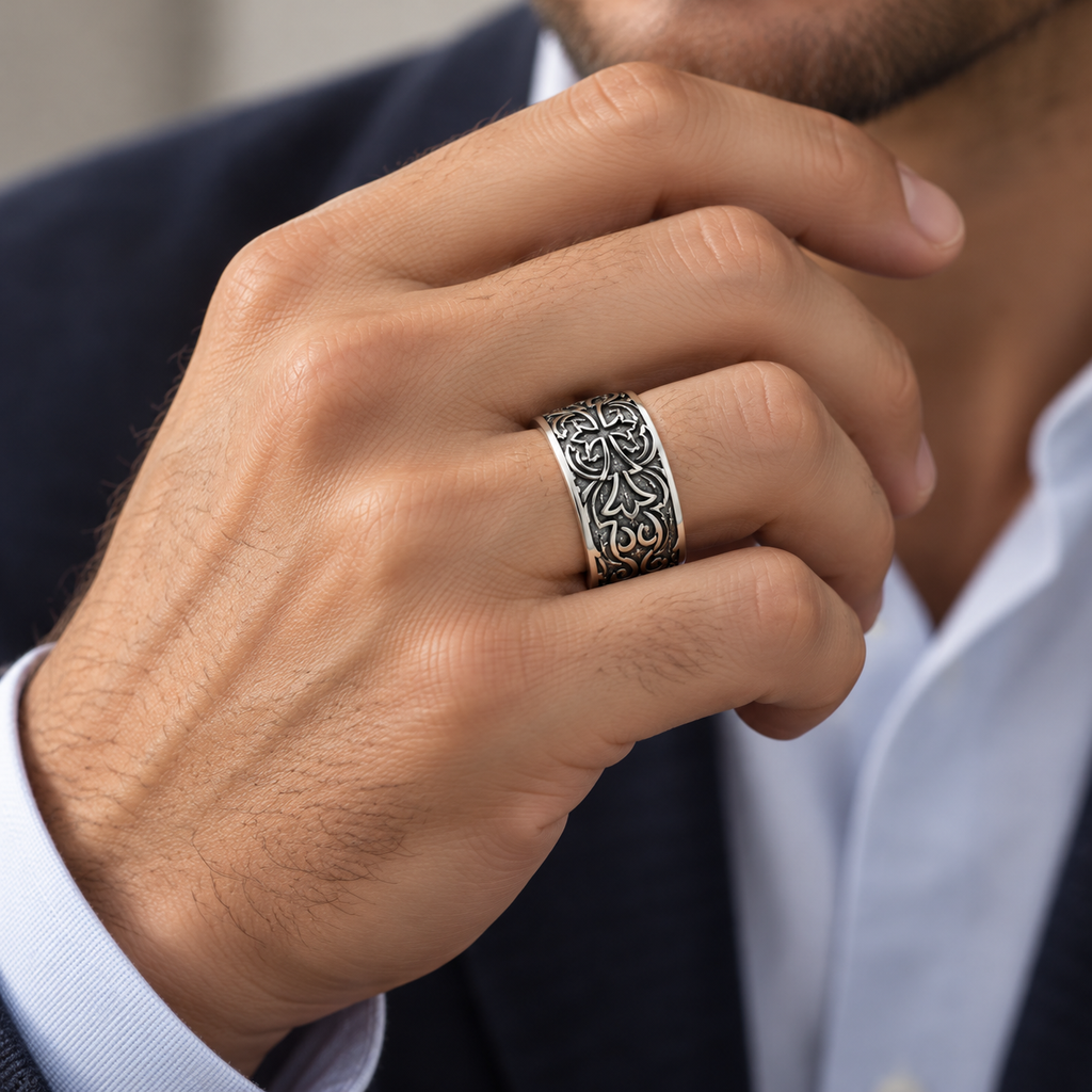 Male hand touching chin wearing stainless steel gothic floral cross band ring
