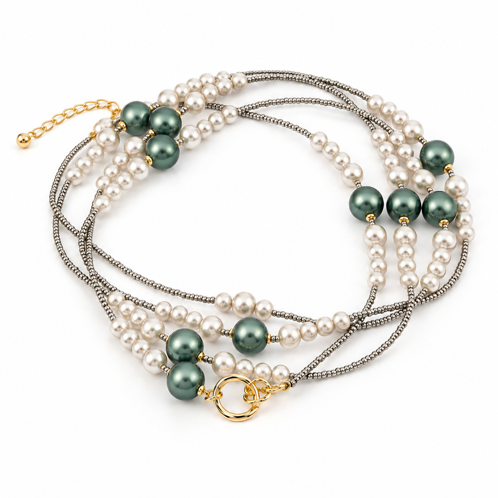 Full product view of the multi-strand pearl and green bead layered bracelet laid flat showing the extender chain and secure clasp.
