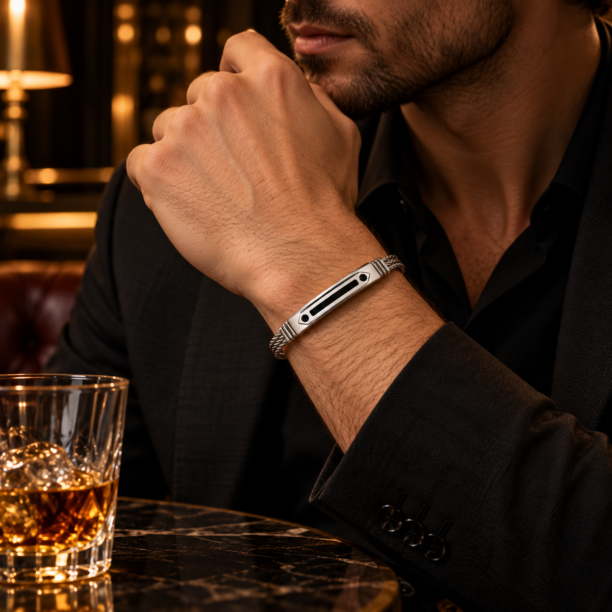Model wearing men's stainless steel geometric black CZ wire cable bracelet with formal black suit
