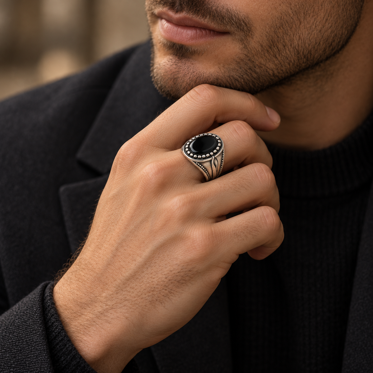 Close up of deep black onyx cabochon stone with studded halo border
