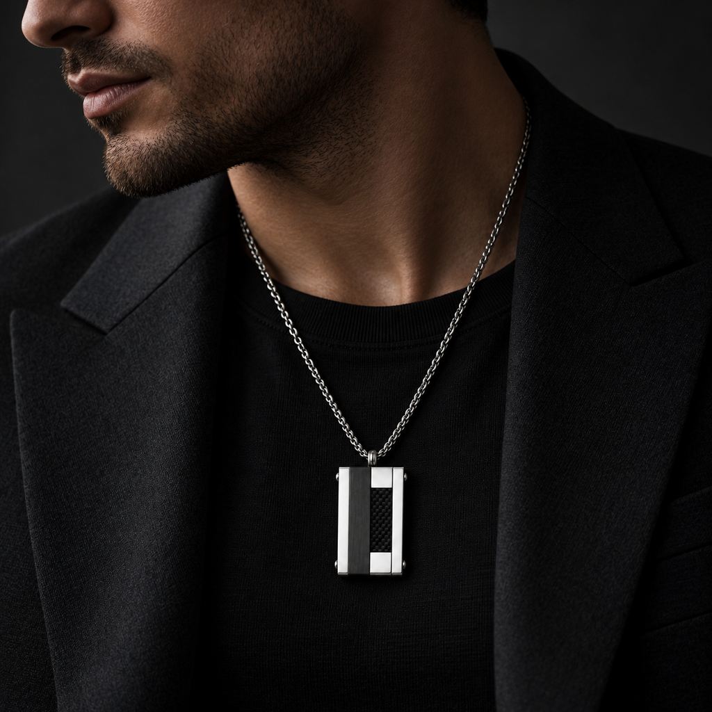 Model wearing men's geometric carbon fiber tag pendant necklace with tailored black suit
