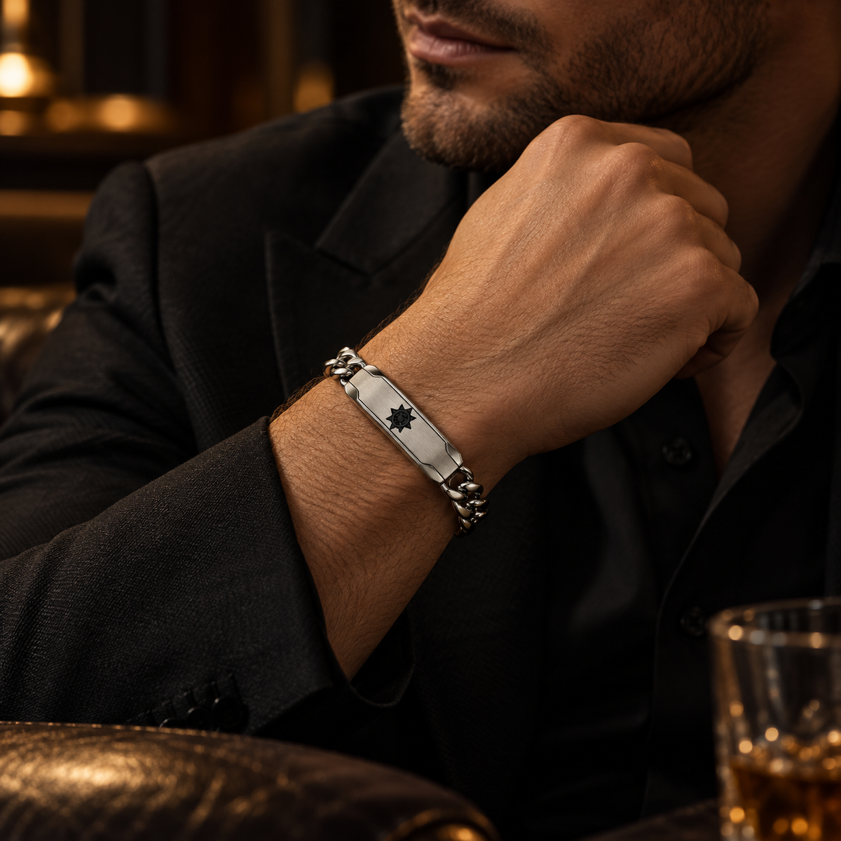 Model wearing men's steel Cuban link solar ID bracelet with black tailored blazer
