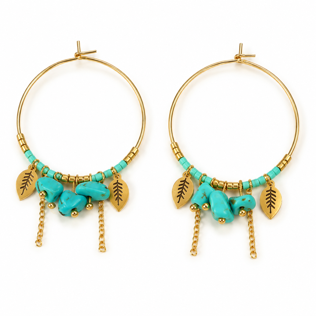 Pair of women's boho gold hoop earrings with turquoise stone beads, leaf charms, and dangling chain tassels on white background
