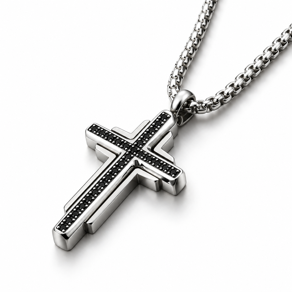 Macro studio angle of men's tiered black stone cross pendant on reflective white surface
