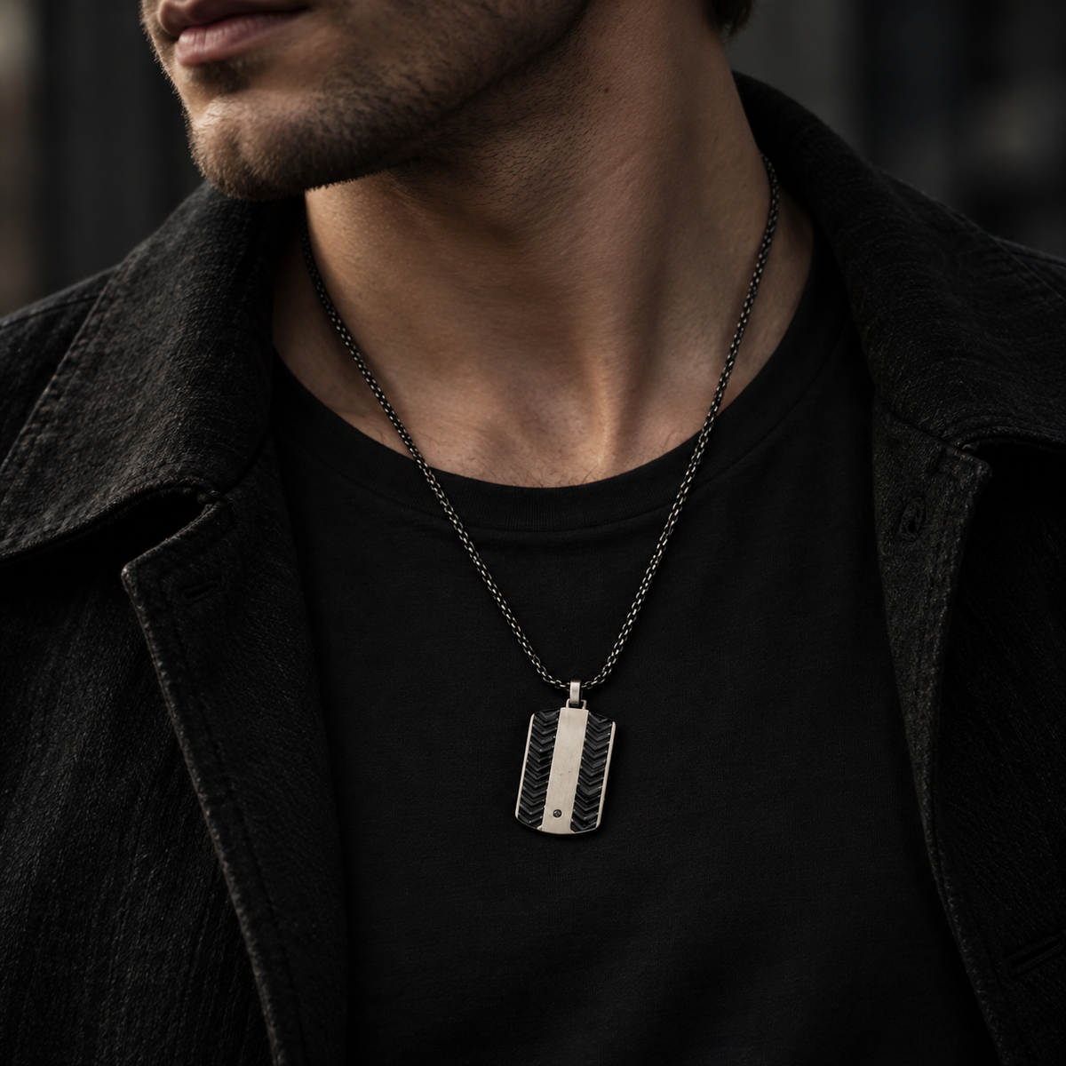 Close-up chest shot of model wearing men's black chevron dog tag necklace
